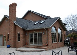You would need to seal the knee walls in a house like this, which has a bonus room over the garage. (Photo: Kenn W. Kiser/morguefile.com)