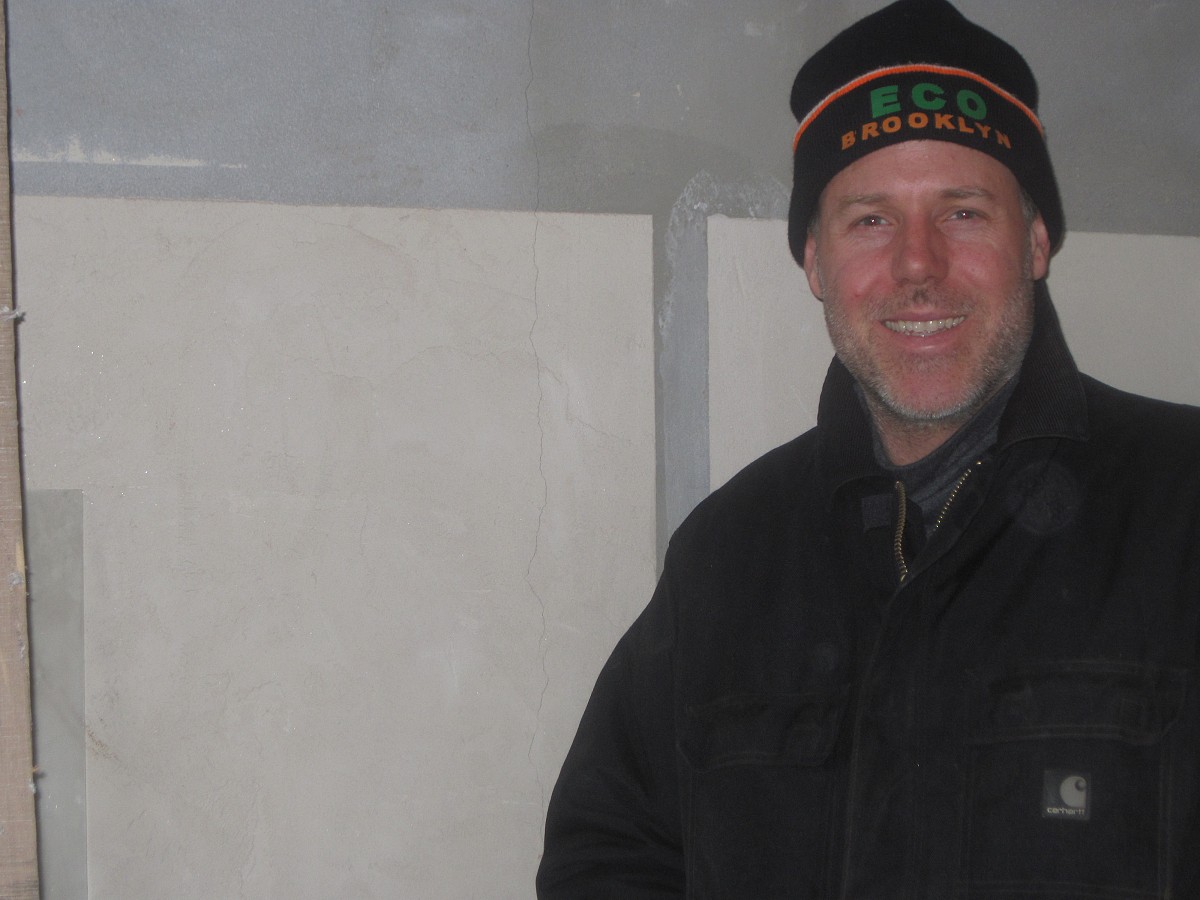 Gennaro in front of clay wall panels on a jobsite in Carroll Gardens, Brooklyn.