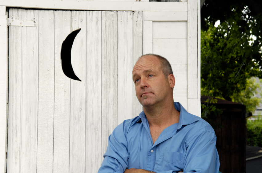 A man waits for the outhouse. Maybe he should have brought his mobile toilet. Photo: twilightproductions/istockphoto.com.