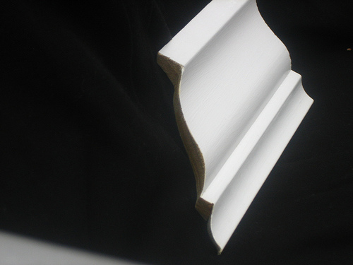 Here's what coped molding looks like: note how it's been cut along the edge of the molding. Photo: Brian Moloney/Flickr