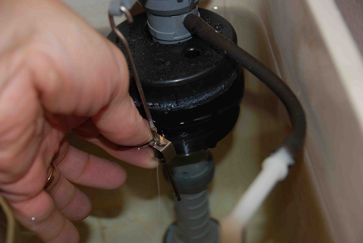 Adjusting the float level on a modern (cylinder-float) fill valve.