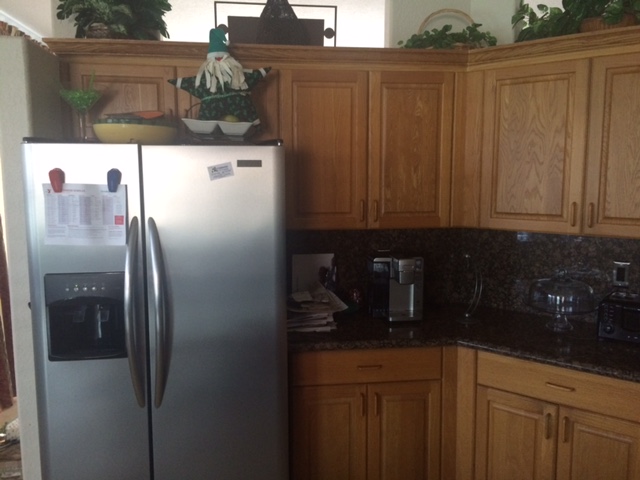 Before: Dark kitchen with original cabinet finish