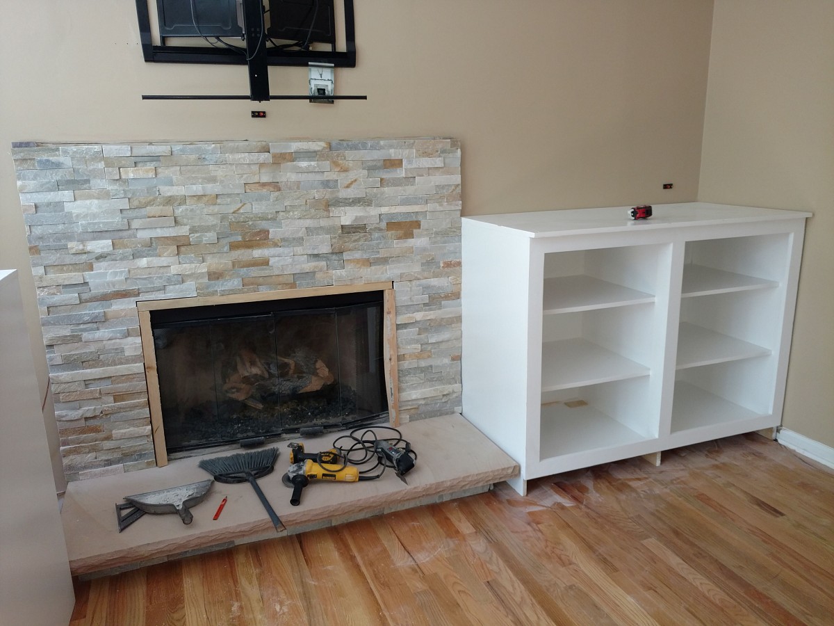 Finished fireplace with damage to hardwood floor